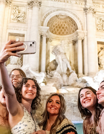 Travellers taking a selfie with the Trevi Fountain, Rome, Italy