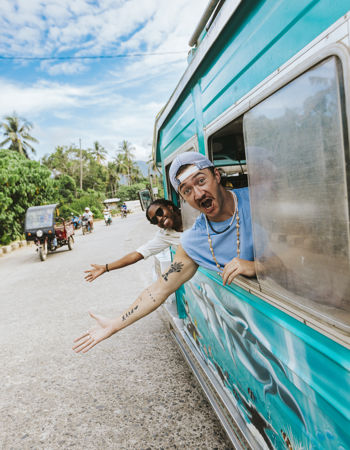 Travellers Waving from Jeepney on Road, Philippines