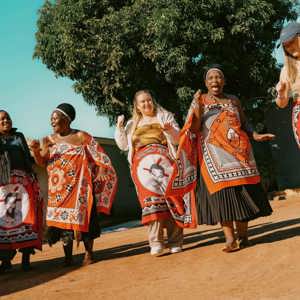 Group join a traditional Swazi dance performance with local community members - Contiki Kruger & Eswatini Safari Tour