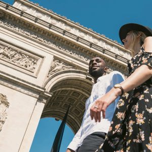 Contiki travellers visiting the Arc de Triomphe in Paris, France, during the London to Berlin by Train Tour, exploring iconic European landmarks and city sights