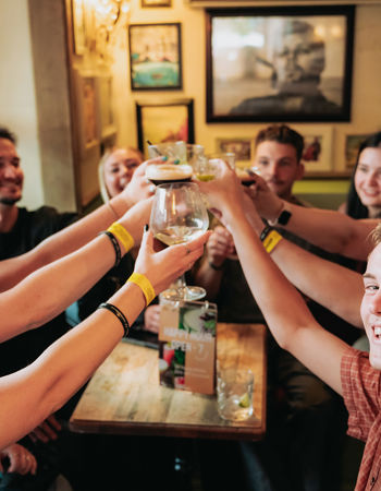 Travellers toasting in a pub, Queenstown, New Zealand