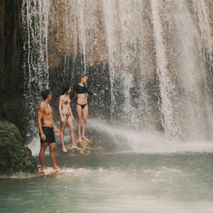 Travellers swimming beneath a tropical waterfall in Northern Thailand - Contiki Chiang Mai & Pai Tour