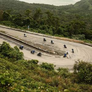Contiki travellers riding scooters along Vietnam's iconic Hải Vân Pass on Contiki's Ride Vietnam Tour