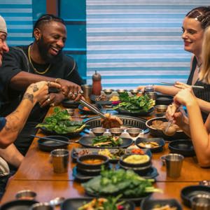 Contiki group enjoying Korean barbecue at a restaurant in Seoul, South Korea - Contiki's Best of South Korea Tour