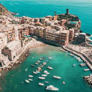 Aerial view of Vernazza's colourful harbour and Mediterranean coastline in Cinque Terre on the Contiki Best of Italy with Sicily Tour