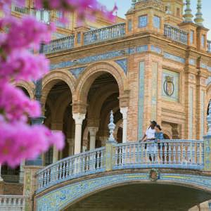 Two people exploring Plaza de España in Seville on Contiki's Madrid to Barcelona Tour in Spain