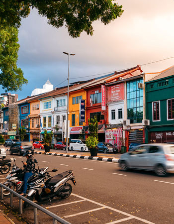 A busy street lined with colourful buildings in Kuching, Borneo, Indonesia