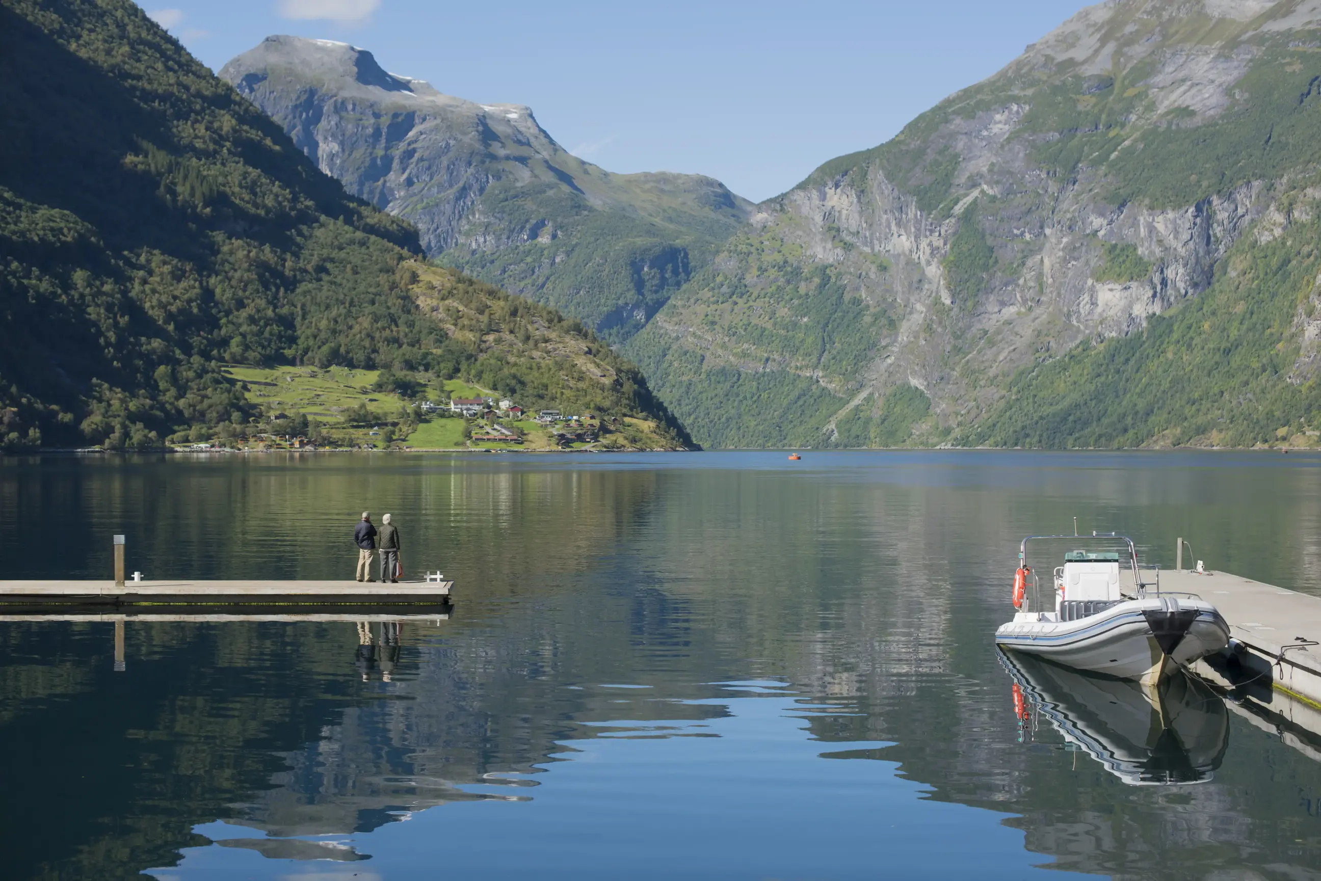 Group of people sitting overlooking Geirangerfjord Western Fjords Norway