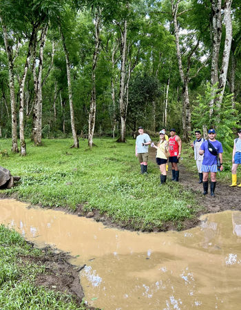 Travellers standing near a tortoise on Isabela Island, Ecuador