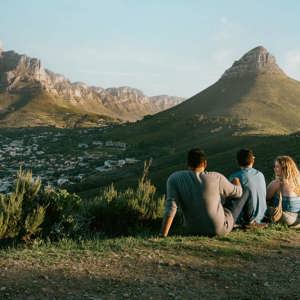 Travellers enjoy panoramic views of Table Mountain and Lion's Head overlooking Cape Town on the Contiki Cape Town, Safari & Falls Tour