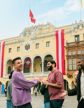 Travellers stood outside of the Municipal Palace in Lima, Peru